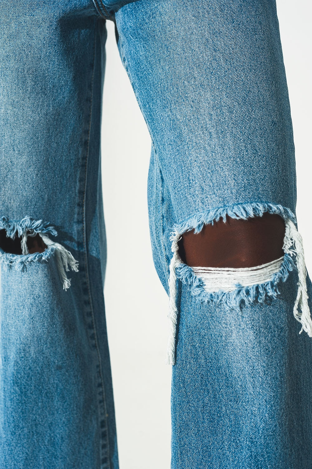 Calças de ganga rectas de lavagem média com rasgos e fendas no fundo