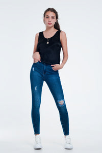 Calças de ganga skinny em apuramento ao meio da lavagem