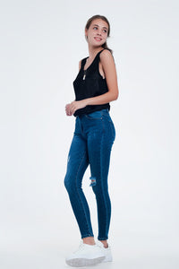 Calças de ganga skinny em apuramento ao meio da lavagem