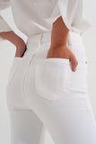 Calças de ganga slim fit com fecho e botão assimétrico em creme