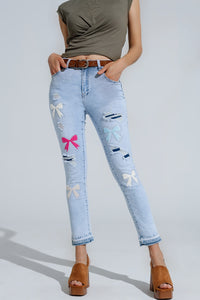 Calças de ganga super skinny azuis claras com laços e buracos rasgados