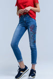 Calças jeans magras com flores pintadas