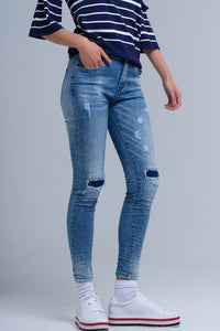Calças jeans skinny com rips