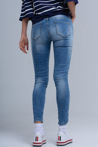 Calças jeans skinny com rips