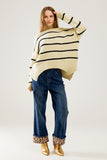 Camisola grande de cor creme com riscas pretas