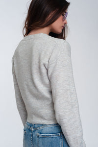 Cardigan curto de malha cinza claro com botões dianteiros