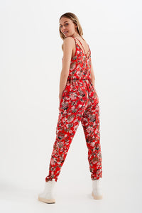 Macacão comprido com estampa floral e tiras finas em vermelho