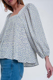 Top floral azul com decote quadrado e mangas insufláveis